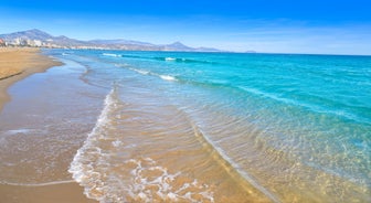 Photo of aerial panoramic view coastline and La Vila Joiosa Villajoyosa touristic resort townscape, sandy beach and Mediterranean seascape, Costa Blanca, Spain.