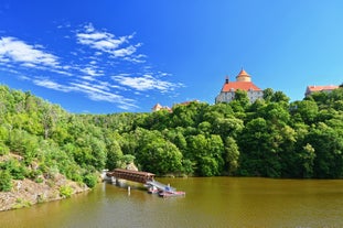 Photo of Lednice Chateau with beautiful gardens and parks on a sunny summer day, Czech Republic.