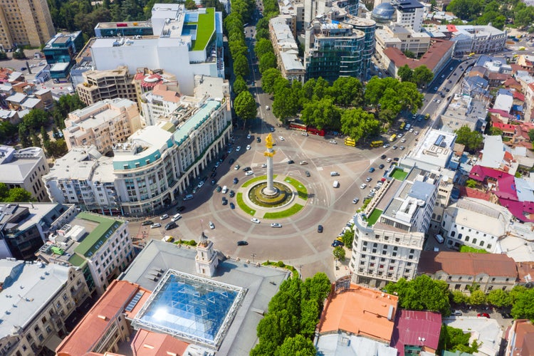 photo of an aerial view of Tbilisi, Georgia. Liberty Monument Depicting St George Slaying The Dragon And Tbilisi City Hall In Freedom Square In City Center. Famous Landmark.