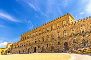 Photo of Italy Piazza Maggiore in Bologna old town tower of town hall with big clock and blue sky on background, antique buildings terracotta galleries.