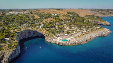 Photo of aerial view of Otranto town in Puglia with crystal turquoise waters, Italy.