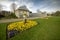 Photo of Colourful flowers in bloom grwoing in front of the victorian glass/green house at the Sheffield Botanical Gardens, South Yokshire, England, UK.