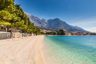 Photo of panorama and landscape of Makarska resort and its harbour with boats and blue sea water, Croatia.