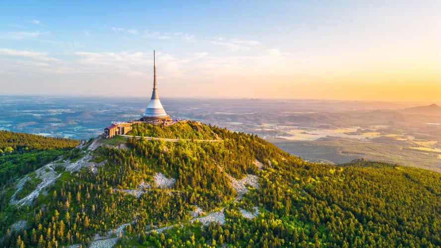 Sunny evening at Jested Mountain with unique building on the summit. Liberec, Czech Republic. Aerial view from drone.