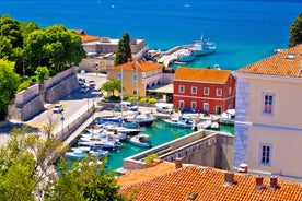 Photo of panorama and landscape of Makarska resort and its harbour with boats and blue sea water, Croatia.