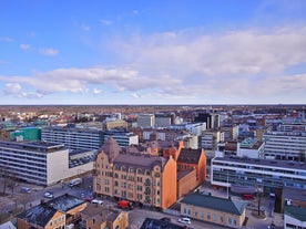 Aerial view of the Tampere city at sunset. Tampella building. View over Tammerkoski river in warm sunlight.