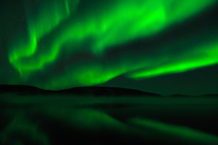 Photo of beautiful green aurora borealis in Finnish lapland.