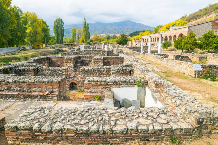 Photo of Historical site with ruins of Heraclea city with no people surounded by mountains nature in Bitola. Macedonia sightseeing historical objects .