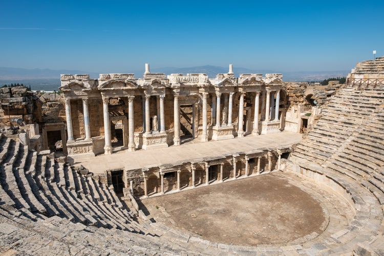 Photo of ruins of a large amphitheater in the ancient city of Hierapolis near Pamukkale, Denizli, Turkey. 