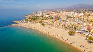 Photo of aerial panoramic view coastline and La Vila Joiosa Villajoyosa touristic resort townscape, sandy beach and Mediterranean seascape, Costa Blanca, Spain.