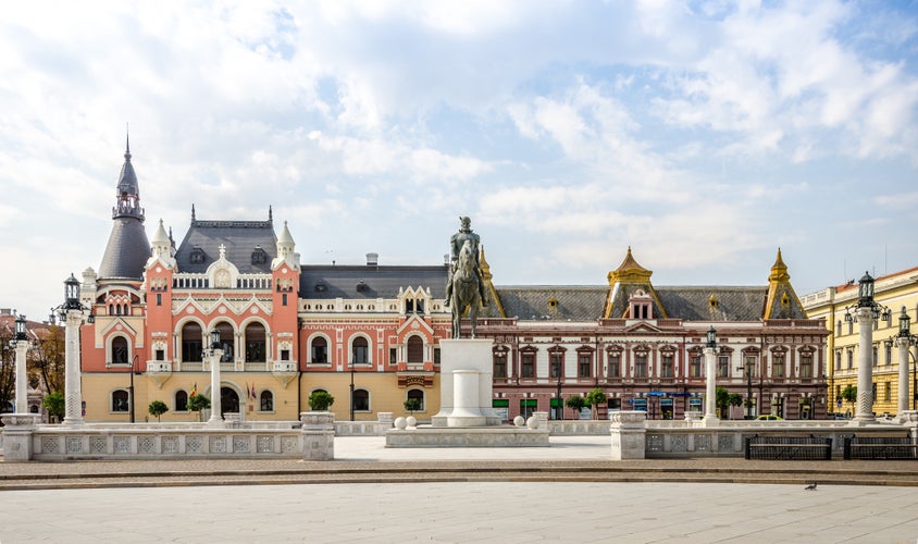 Oradea, Romania: Mihai Viteazu (Michael the Brave) Statue in the Unirii Square with the Greek-Catholic Episcopal Palace.