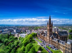 Photo of aerial view of Aberdeen as River Dee flows in a curve to the North Sea showing Duthie Park with bridge and traffic from south.