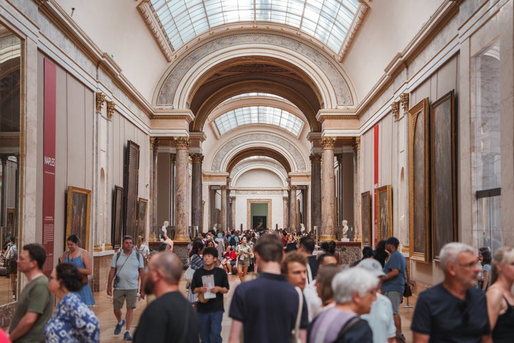 group of people walking through a museum in Paris.jpg