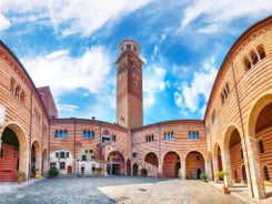 Photo of aerial view of Verona historical city centre, Ponte Pietra bridge across Adige river, Verona Cathedral, Duomo di Verona, red tiled roofs, Veneto Region, Italy.