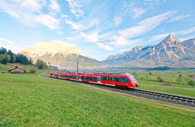 Photo of aerial view of the city of Lermoos, Austria with the Alps mountains in the background on a sunny summer day.