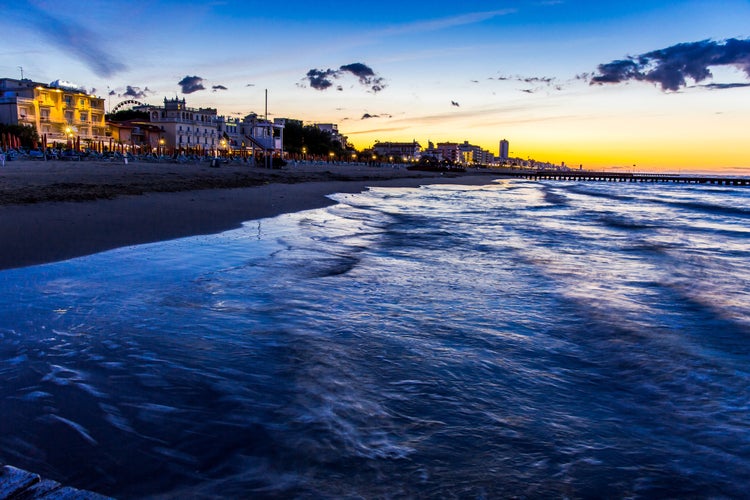 View at the beach and hotels from pier at sunrise, Jesolo, Italy.