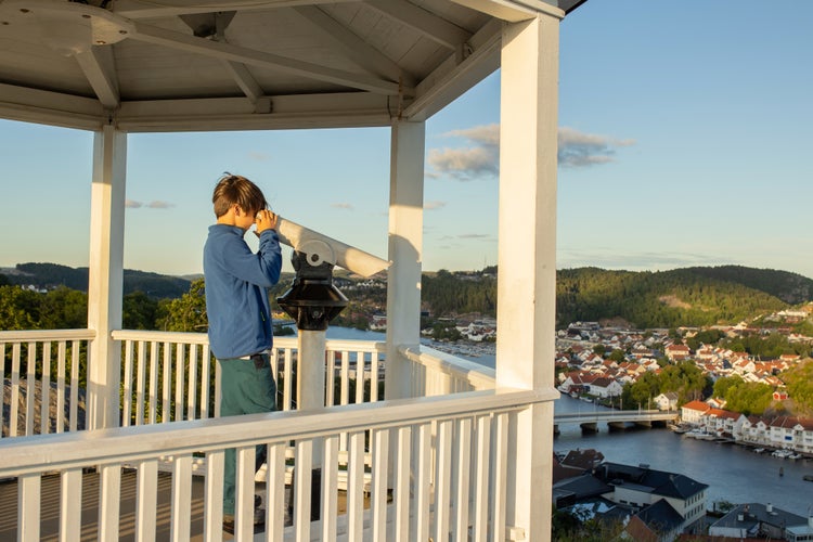 Family visiting town Mandal in Norway, view from the viewpoint Uranienborg to the city Mandal in Norway