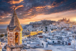 Photo of panoramic view of the ancient town of Matera (Sassi di Matera), European Capital of Culture 2019, in beautiful golden morning light with blue sky and clouds, Basilicata, southern Italy.