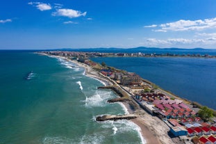 Photo of Saint Anastasia Island in Burgas bay, Black Sea, Bulgaria. Lighthouse tower and old wooden buildings on rocky coast.