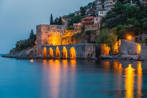 View of ancient shipyard near of Kizil Kule tower in Alanya peninsula, Antalya district, Turkey, Asia. Famous tourist destination with high mountains. Part of ancient old Castle.