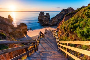 Photo of wide sandy beach in white city of Albufeira, Algarve, Portugal.