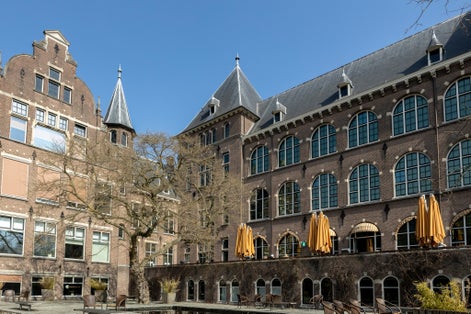 photo of restaurant and exterior facade architecture of historic building Tropenmuseum in Amsterdam, The Netherlands. Dutch education and institution of foreign relations.