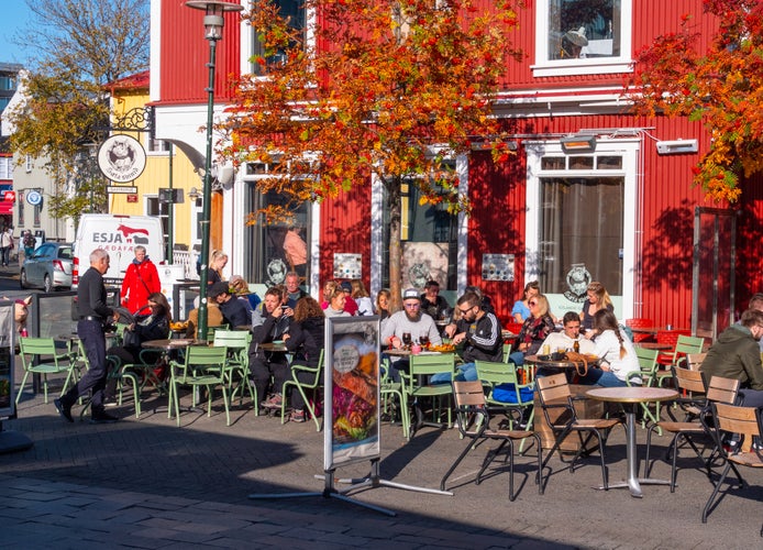 Diners eating outside in autumn sunshine in Iceland.jpg