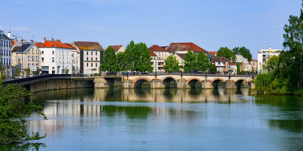 photo of view of Market bridge spanning the Marne river in the city center of Meaux, France.