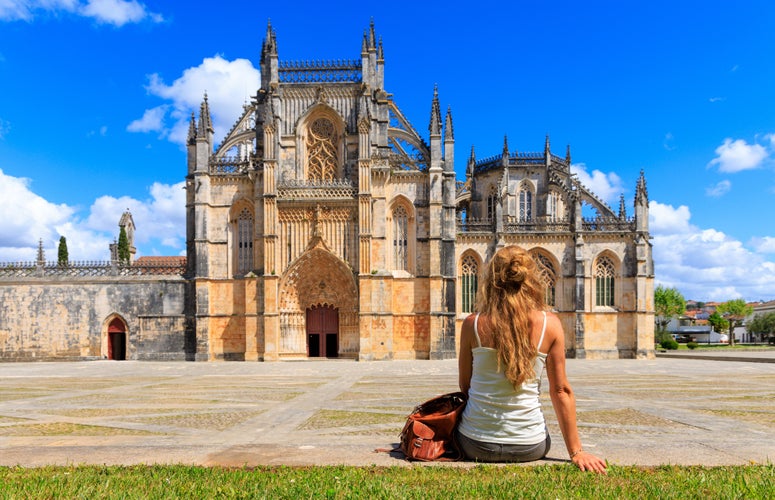 Woman tourist in front of The Monastery of Batalha- Portugal, Leiria