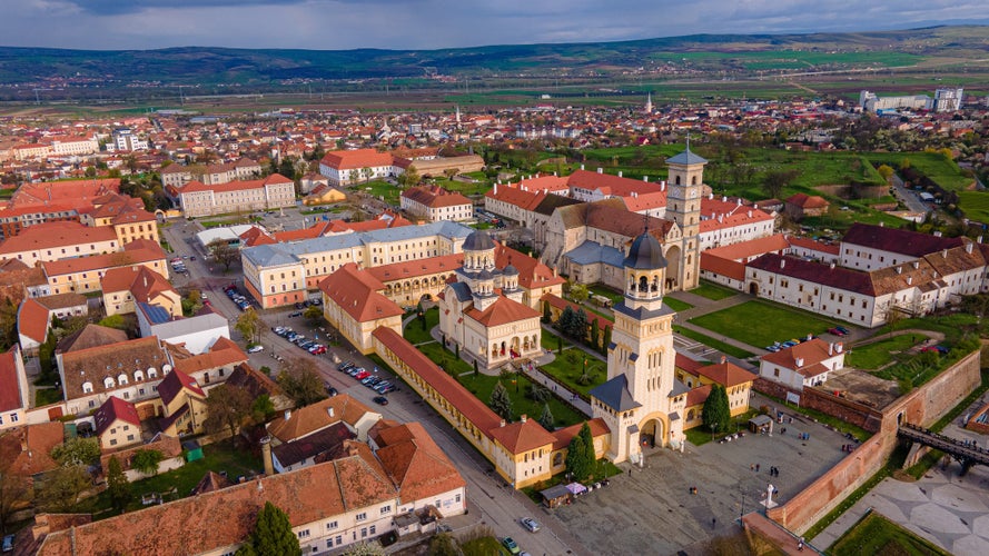 photo of view of Aerial view of the Alba Carolina citadel located in Alba Iulia, Romania. In the photography can be seen the Reunification Cathedral from above, shot from a drone with camera level for a panoramic view