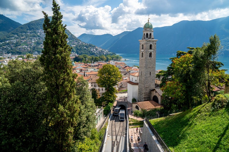 Photo of Lugano City - Ticino - during late Summer with the funicular and the San Lorenzo Church and the Lago di Lugano in the background, Switzerland.