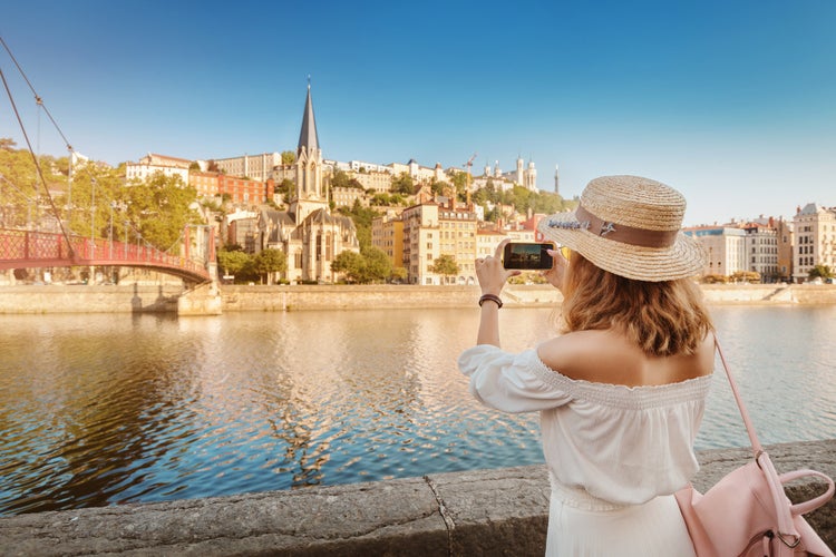 Photo of tourist walks through the center of Lyon's old town, France.