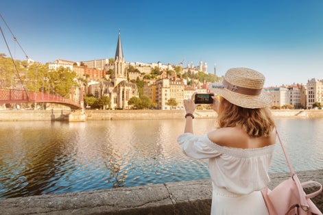 Photo of tourist walks through the center of Lyon's old town, France.