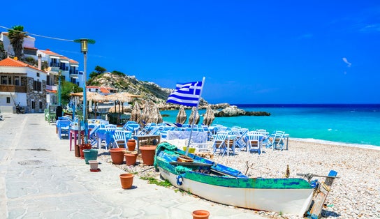 Photo of Samos island, Greece. Beautiful beach and tavern in scenic Kokkari village.