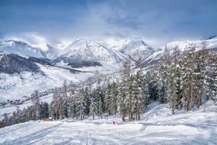 Photo of aerial view of Livigno town covered in snow in winter, Italy.