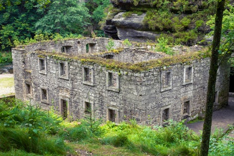 Photo of beautiful aerial view of abandoned Dolsky Mill in the valley of the Kamenice river, Czech Republic.