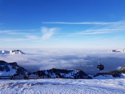 Photo of Dornbirn at sunset with a view of the meadows, forests and snowy mountains in background, Austria.