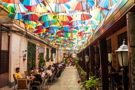Cafe with colorful umbrellas on a street in Bucharest.