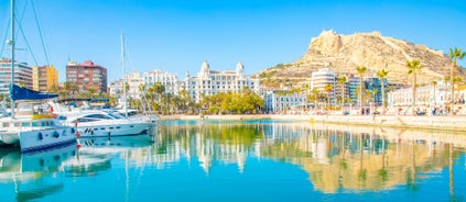 Photo of aerial panoramic view coastline and La Vila Joiosa Villajoyosa touristic resort townscape, sandy beach and Mediterranean seascape, Costa Blanca, Spain.