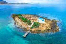 Photo of aerial view of Malia beach and small island with Church of Transfiguration, Heraklion, Crete, Greece.