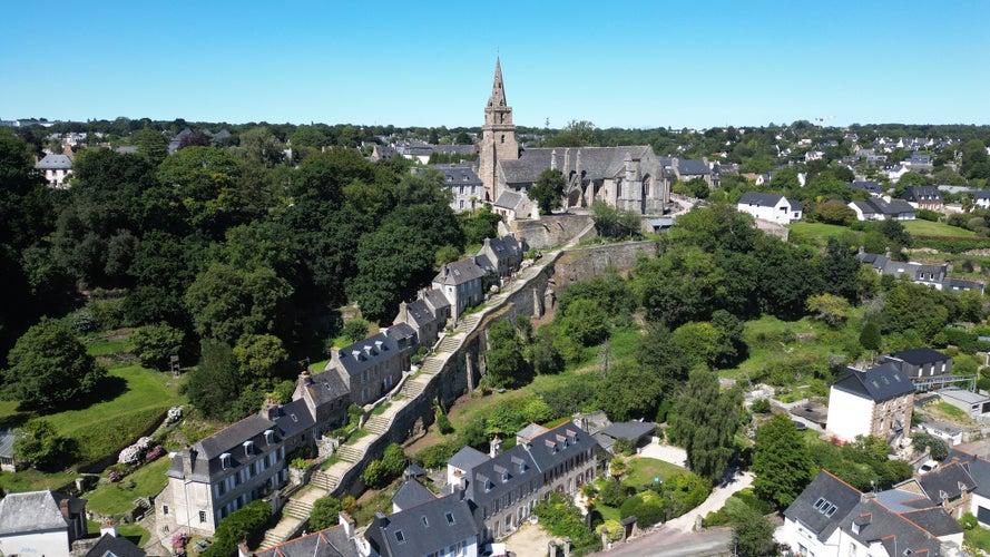 Famous stone staircase of Brélévenez, Lannion, 152 steps, with church of trinity at the top, aerial view , on a sunny day. French Britany, cotes d'Armor.