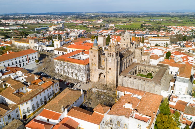 Evora drone aerial view on a sunny day with historic buildings city center and church in Evora Alentejo, Portugal