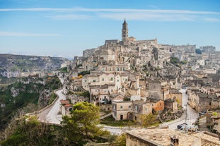 Photo of panoramic view of the ancient town of Matera (Sassi di Matera), European Capital of Culture 2019, in beautiful golden morning light with blue sky and clouds, Basilicata, southern Italy.