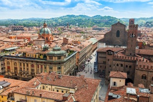 Photo of aerial view of Verona historical city centre, Ponte Pietra bridge across Adige river, Verona Cathedral, Duomo di Verona, red tiled roofs, Veneto Region, Italy.