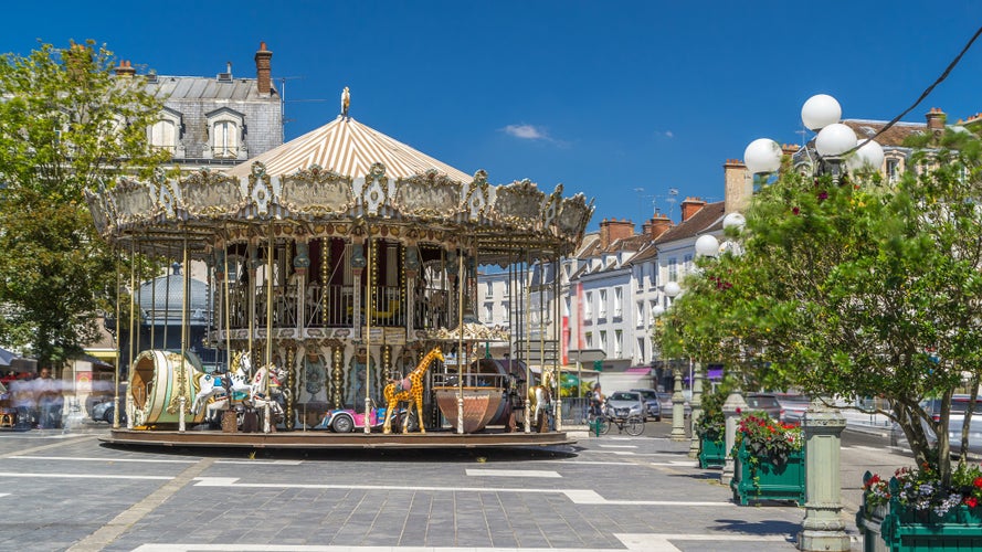 Carousel spinning on the main square of Fontainebleau timelapse hyperlapse. Historic buildings on background