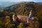 Aerial top view of Grodno castle in Zagorze with beautiful autumn landscape. Old historical fortress in mountains, covered with forest. Poland landmarks for tourists