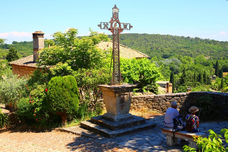 Photo of La Roque-sur-Cèze, France - June 2021: A cross in the small village in the south of France .