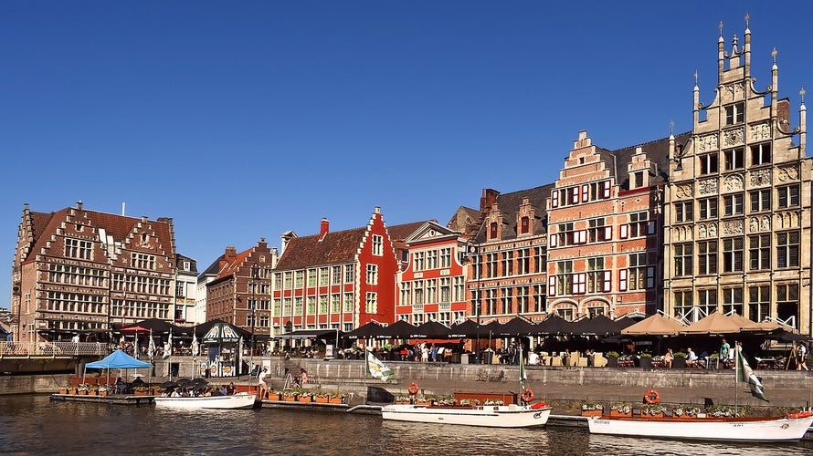 Photo of Row of historic buildings along the tourist boats floating on the river, Ghent, Belgium