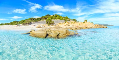 Photo of aerial view of a beautiful bay with azure sea from top of a hill, Villasimius, Sardinia island, Italy.