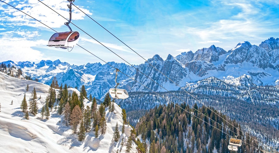 photo of winter landscape in Dolomites at Cortina D'Ampezzo ski resort, Italy, Monte Castello area, chair lift installation.